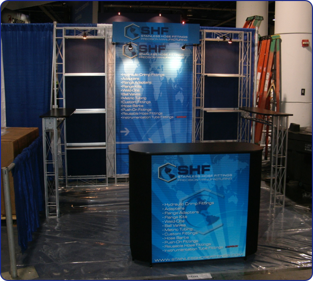 Stainless Hose Fittings needed a quick and easy solution for their 10 x 10 space at ConExpo without looking well.. quick and easy. This Belmont fit the bill with navy satin fabric panels behind our aluminum truss shelves. A large center graphic made the display look like it was custom built for them.